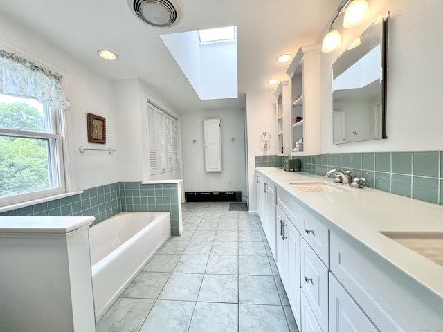 4 Johnny Cake Hill Rd, Old Lyme, CT 06371 - full bathroom featuring double vanity, a garden tub, a skylight, marble look tile flooring, and recessed lighting