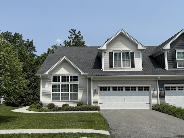 17 Wilderswood Way Unit 17, Danbury, CT 06810 - view of front of house with asphalt driveway, a garage, roof with shingles, and a front yard