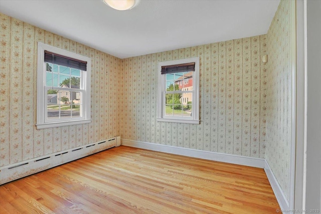 209 Roxbury Rd, New Britain, CT 06053 - unfurnished room featuring a baseboard radiator, healthy amount of natural light, and wood finished floors