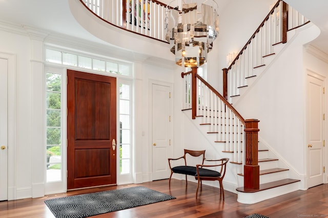474 Ponus Rdg, New Canaan, CT 06840 - entrance foyer with a chandelier, stairway, wood finished floors, crown molding, and a high ceiling
