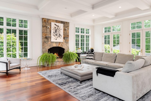474 Ponus Rdg, New Canaan, CT 06840 - living room featuring coffered ceiling, beam ceiling, wood finished floors, a stone fireplace, and ornamental molding