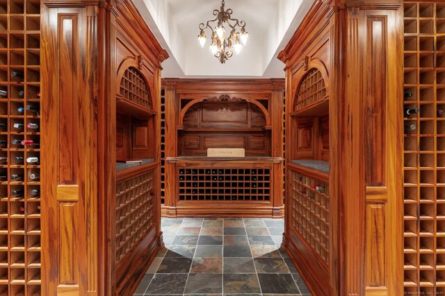474 Ponus Rdg, New Canaan, CT 06840 - wine area featuring stone tile floors and a chandelier