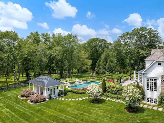 474 Ponus Rdg, New Canaan, CT 06840 - view of green lawn with an outdoor pool, view of scattered trees, and a patio