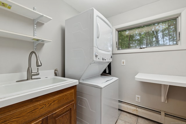 24 Quince Ct, Bristol, CT 06010 - laundry room with stacked washing machine and dryer, baseboard heating, light tile patterned flooring, and cabinet space