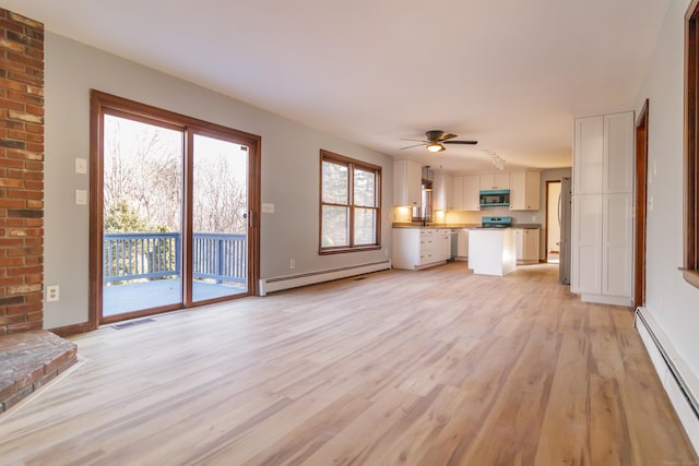 155 Melinda Ln, Bristol, CT 06010 - unfurnished living room featuring a baseboard heating unit, light wood-style flooring, and a ceiling fan