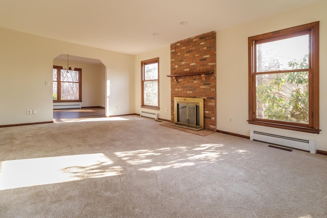 155 Melinda Ln, Bristol, CT 06010 - unfurnished living room featuring a baseboard heating unit, carpet, arched walkways, and a brick fireplace