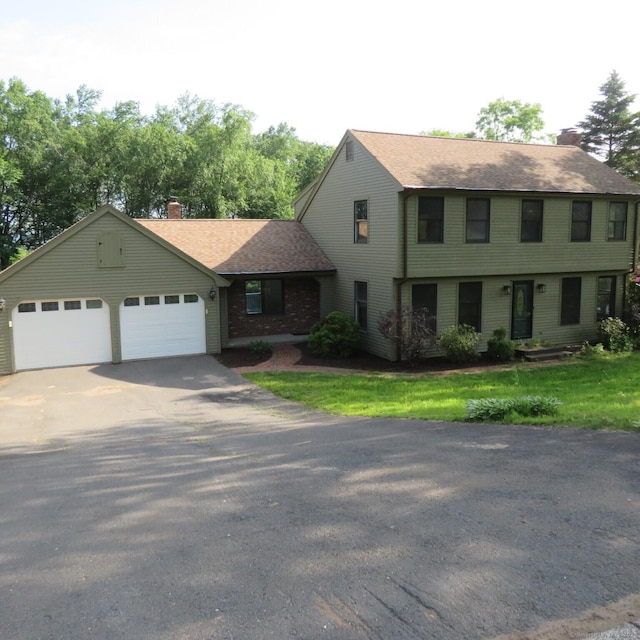 155 Melinda Ln, Bristol, CT 06010 - colonial-style house featuring asphalt driveway, a chimney, an attached garage, and roof with shingles