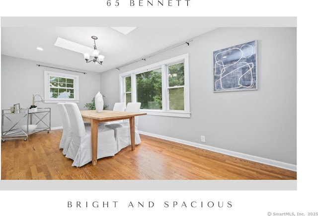 65 Bennett St, Fairfield, CT 06825 - dining space featuring a chandelier, wood finished floors, a skylight, and recessed lighting