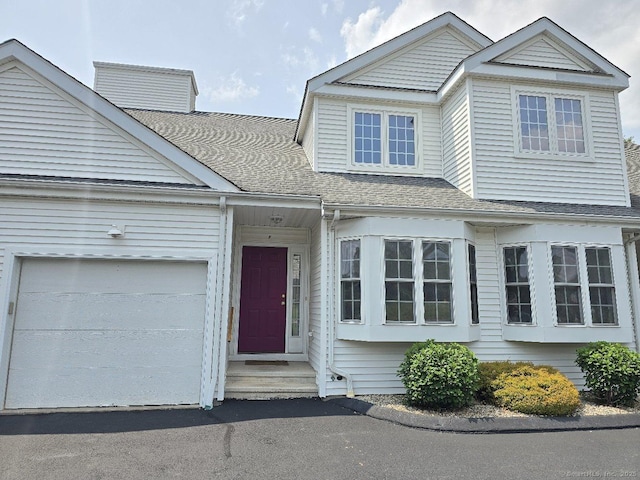 244 Oakland St Apt F, Manchester, CT 06042 - view of front of house featuring a garage, roof with shingles, and driveway
