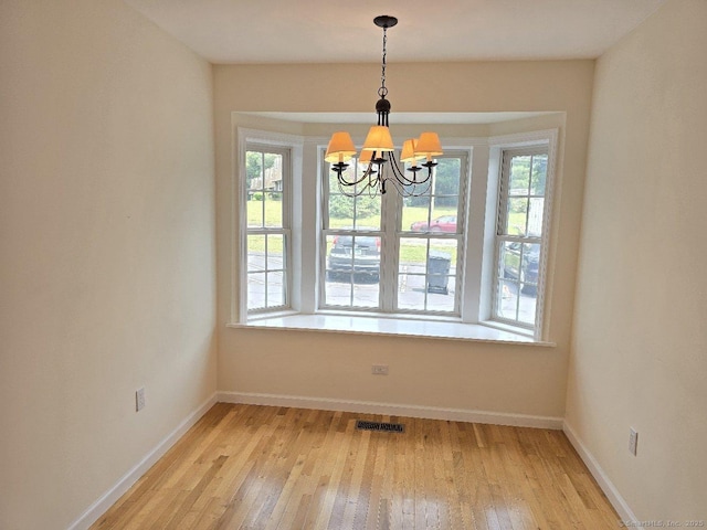244 Oakland St Apt F, Manchester, CT 06042 - unfurnished dining area with a chandelier and light wood-type flooring