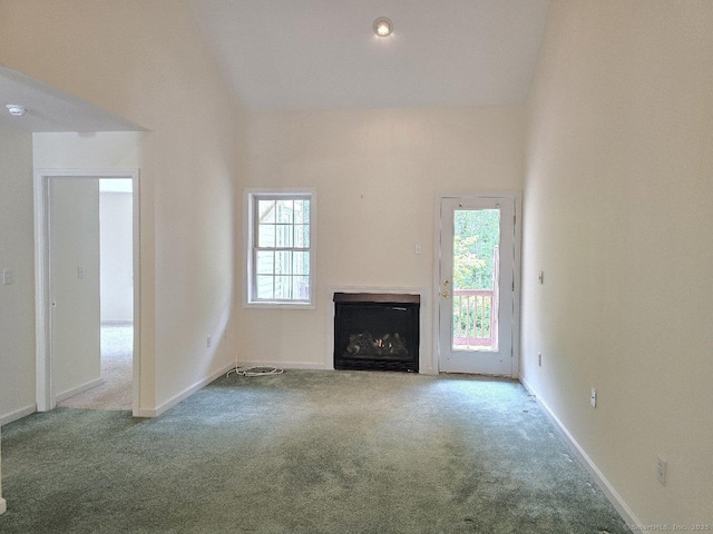 244 Oakland St Apt F, Manchester, CT 06042 - unfurnished living room with carpet floors, a fireplace, and lofted ceiling