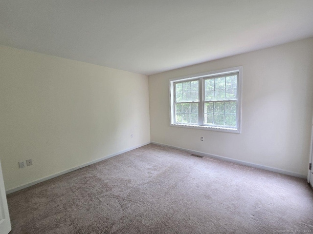 244 Oakland St Apt F, Manchester, CT 06042 - carpeted empty room featuring baseboards