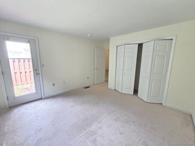 244 Oakland St Apt F, Manchester, CT 06042 - unfurnished bedroom with light carpet and a closet