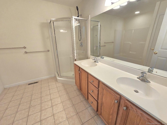 244 Oakland St Apt F, Manchester, CT 06042 - bathroom featuring a shower stall, double vanity, and tile patterned flooring