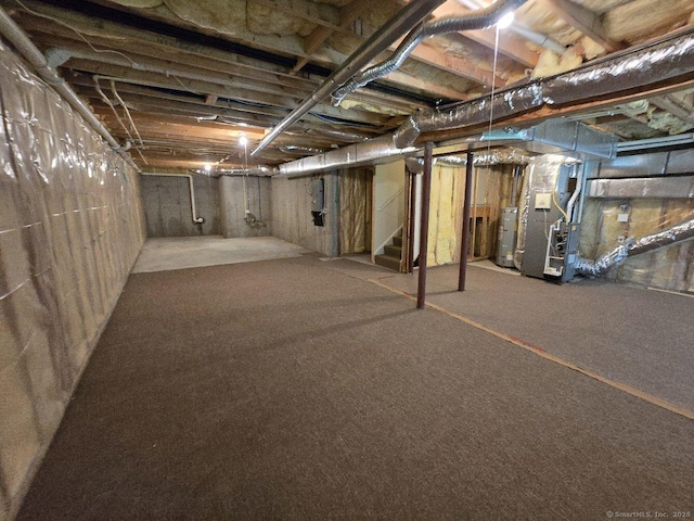 244 Oakland St Apt F, Manchester, CT 06042 - unfinished basement with water heater, stairs, electric panel, heating unit, and carpet flooring