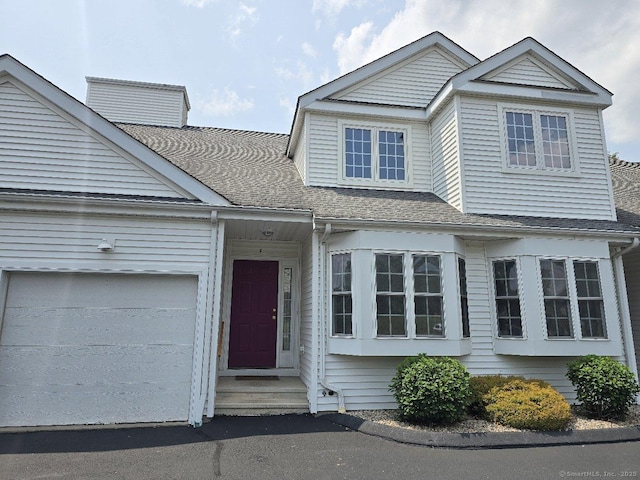 244 Oakland St Apt F, Manchester, CT 06042 - view of front of home with roof with shingles and an attached garage
