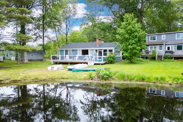 5 Lake Pt, Haddam, CT 06441 - back of house with a sunroom, a deck with water view, a chimney, and a lawn