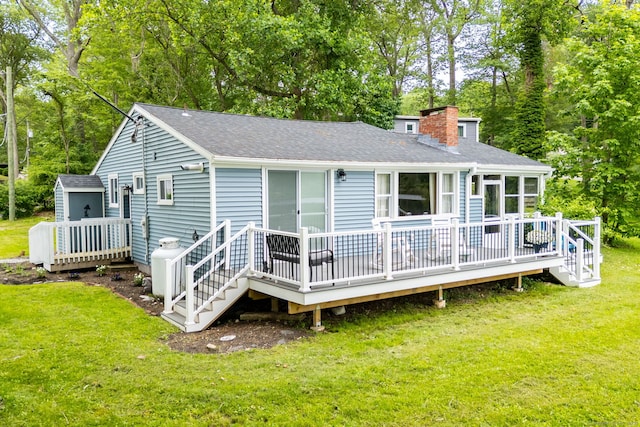 5 Lake Pt, Haddam, CT 06441 - back of property featuring a deck, a chimney, roof with shingles, and a lawn
