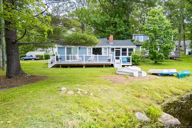 5 Lake Pt, Haddam, CT 06441 - rear view of house with a sunroom, a chimney, a wooden deck, and a lawn