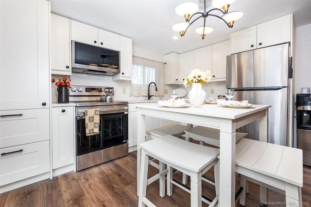 5 Lake Pt, Haddam, CT 06441 - kitchen featuring stainless steel appliances, a chandelier, light countertops, white cabinets, and dark wood finished floors