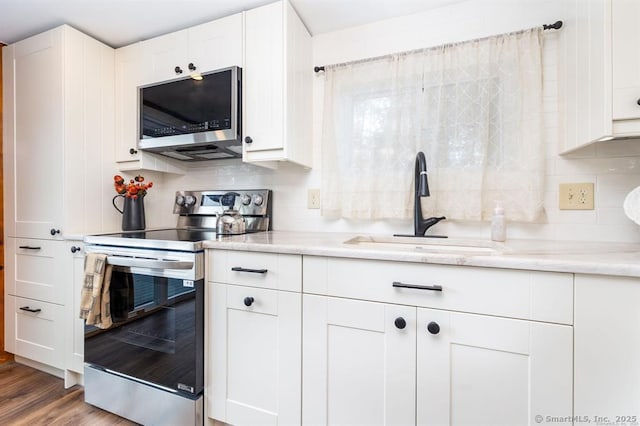 5 Lake Pt, Haddam, CT 06441 - kitchen with stainless steel appliances, white cabinetry, wood finished floors, and backsplash