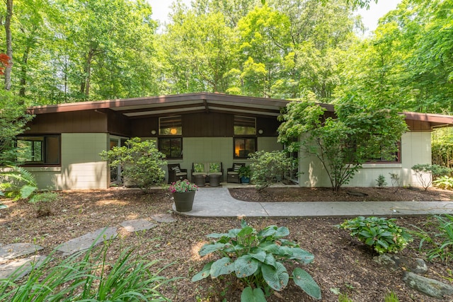 120 Highwoods Dr, Guilford, CT 06437 - view of front of house featuring concrete block siding and a patio
