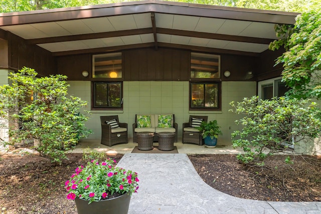 120 Highwoods Dr, Guilford, CT 06437 - property entrance featuring an outdoor hangout area, concrete block siding, and a patio area