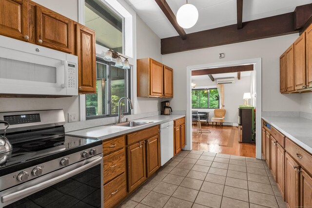 120 Highwoods Dr, Guilford, CT 06437 - kitchen with white appliances, beamed ceiling, a wall mounted air conditioner, light countertops, and light tile patterned floors
