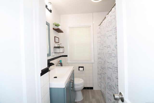 80 Longbranch Ave, Stratford, CT 06615 - full bath featuring vanity, tile walls, wood finished floors, curtained shower, and a wainscoted wall