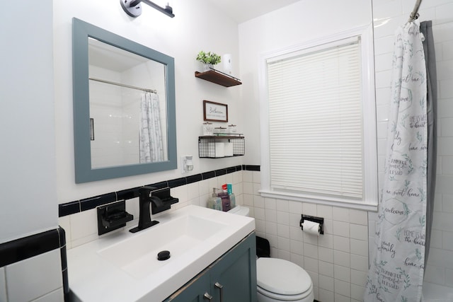 80 Longbranch Ave, Stratford, CT 06615 - bathroom with vanity, tile walls, a shower with shower curtain, and wainscoting