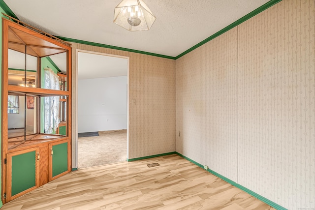 105 Woodland Park, Shelton, CT 06484 - empty room with wood finished floors, crown molding, and a textured ceiling