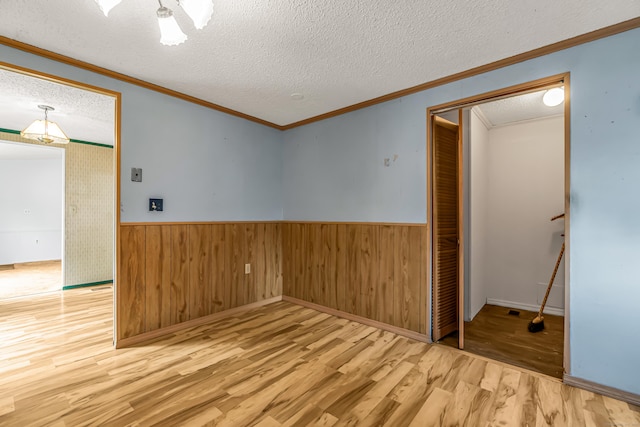 105 Woodland Park, Shelton, CT 06484 - spare room with wood finished floors, a textured ceiling, crown molding, wainscoting, and wooden walls