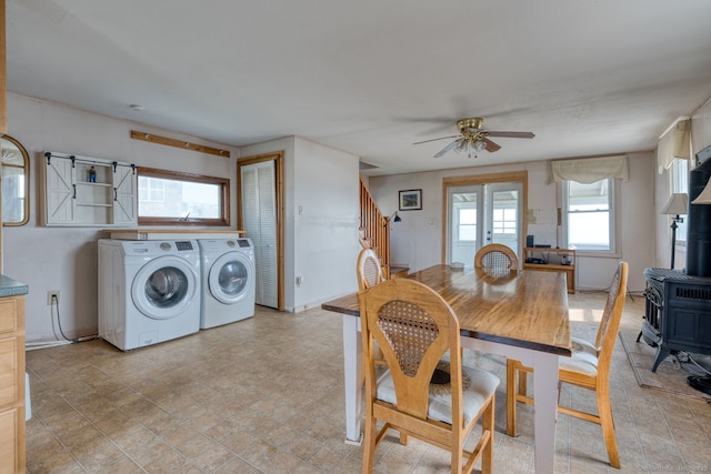 57 Circle Beach Rd, Madison, CT 06443 - dining room featuring washer and clothes dryer, a wood stove, ceiling fan, and stairway