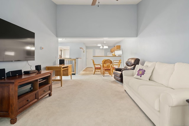 671 Ledgeview Ct Unit 671, Southington, CT 06489 - living area featuring light colored carpet, a ceiling fan, a chandelier, and a towering ceiling