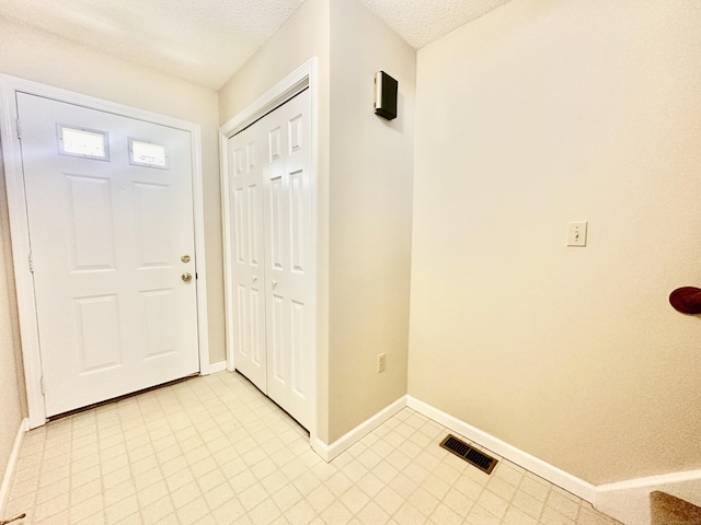 60 Sunrise Cir Unit 60, Newington, CT 06111 - entryway with baseboards and a textured ceiling