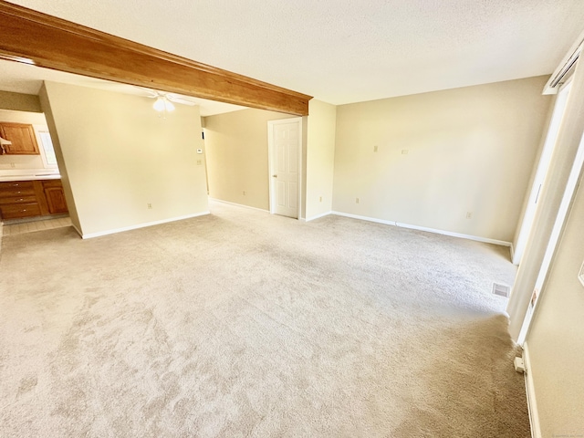 60 Sunrise Cir Unit 60, Newington, CT 06111 - unfurnished room with a ceiling fan, light carpet, beam ceiling, and a textured ceiling