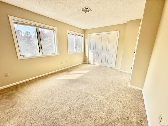 60 Sunrise Cir Unit 60, Newington, CT 06111 - unfurnished bedroom with carpet flooring, a textured ceiling, and a closet