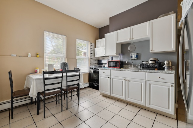 83 James St, New Haven, CT 06513 - kitchen with black appliances, white cabinets, light tile patterned flooring, and backsplash
