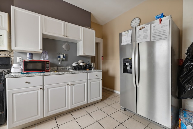 83 James St, New Haven, CT 06513 - kitchen featuring stainless steel refrigerator with ice dispenser, black microwave, white cabinetry, white microwave, and range with electric cooktop