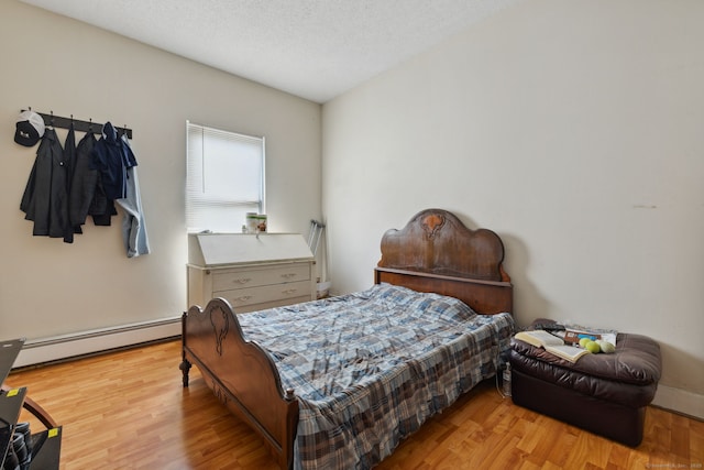 83 James St, New Haven, CT 06513 - bedroom with a baseboard heating unit and wood finished floors