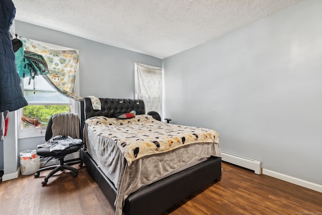 83 James St, New Haven, CT 06513 - bedroom with a baseboard heating unit, wood finished floors, and a textured ceiling