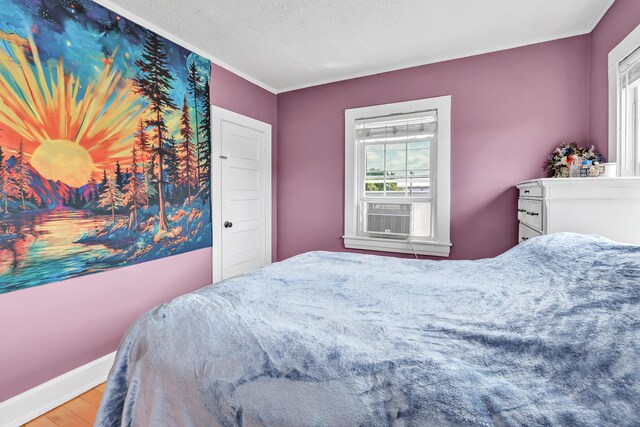819 Connecticut Ave Unit 6, Bridgeport, CT 06607 - bedroom featuring wood finished floors, crown molding, cooling unit, and a textured ceiling