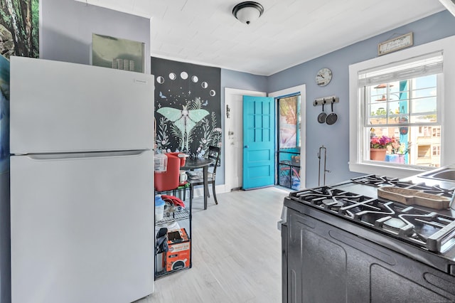 819 Connecticut Ave Unit 6, Bridgeport, CT 06607 - kitchen with freestanding refrigerator, black gas range, and light wood-style flooring