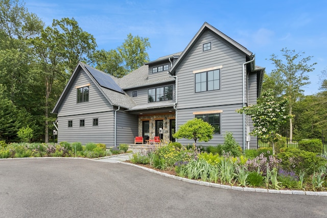 232 Bayberry Ln, Westport, CT 06880 - view of front of property featuring a porch, solar panels, and roof with shingles
