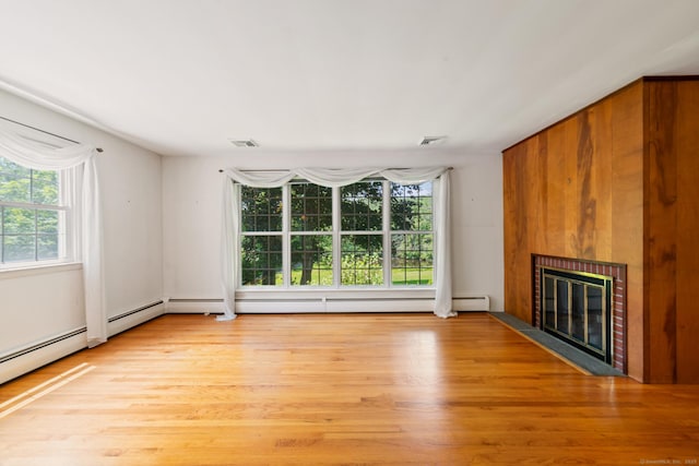 765 Kettletown Rd, Southbury, CT 06488 - unfurnished living room with a fireplace with flush hearth, light wood-type flooring, and a baseboard heating unit