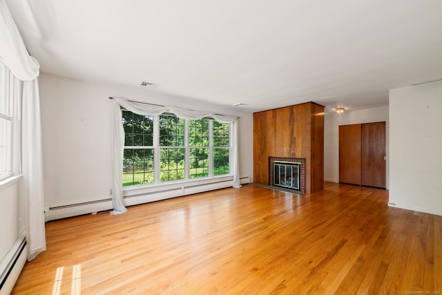 765 Kettletown Rd, Southbury, CT 06488 - unfurnished living room featuring a baseboard heating unit, a brick fireplace, and light wood-style floors