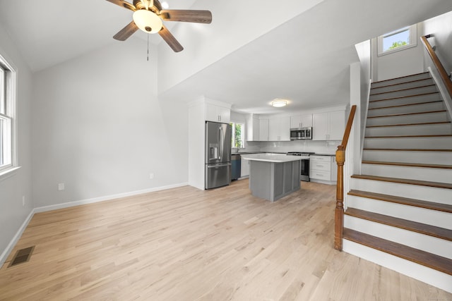 440 Lakeview Dr, Suffield, CT 06093 - kitchen featuring stainless steel appliances, ceiling fan, white cabinets, light wood finished floors, and a kitchen island
