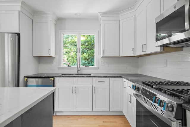 440 Lakeview Dr, Suffield, CT 06093 - kitchen featuring stainless steel appliances, dark stone counters, white cabinetry, and decorative backsplash