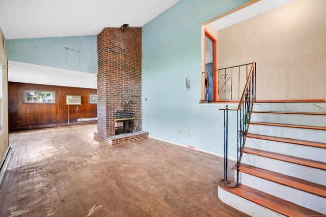 134 Sunset St, Windsor Locks, CT 06096 - unfurnished living room featuring a wall mounted AC, stairs, a fireplace, high vaulted ceiling, and wood finished floors