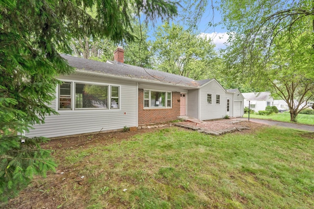 134 Sunset St, Windsor Locks, CT 06096 - ranch-style house featuring a chimney, brick siding, a front yard, and asphalt driveway